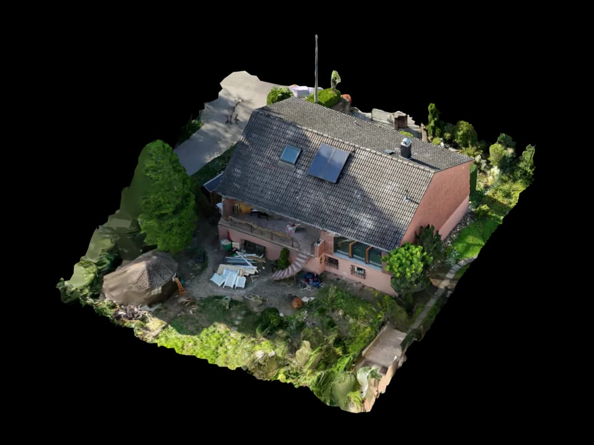 Photogrammetrisches 3D-Modell eines Einfamilienhauses mit dunklem Satteldach und Garten